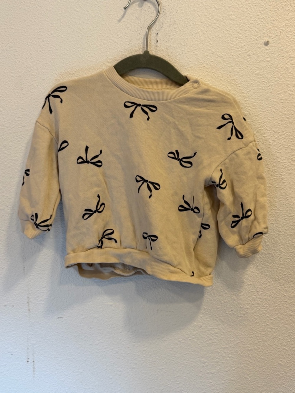 H&M Cream Sweatshirt with Black Bow Motif
